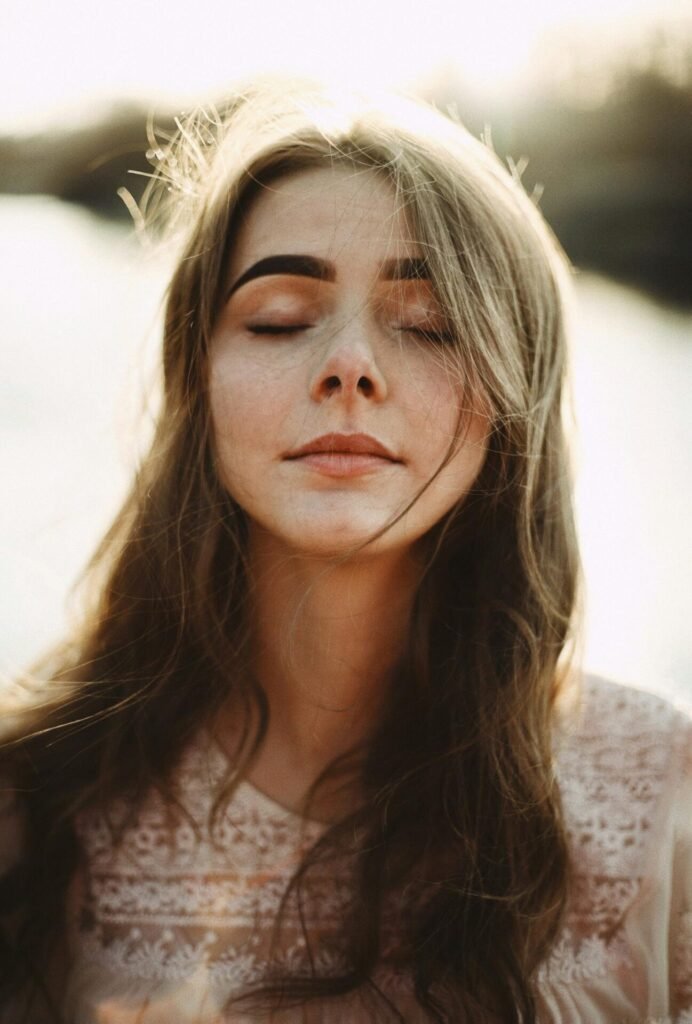 Woman facing front with eyes closed